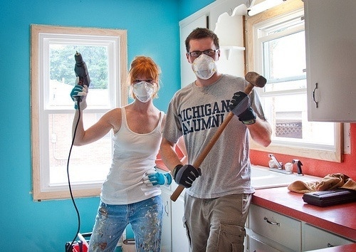 man and woman work on house projects