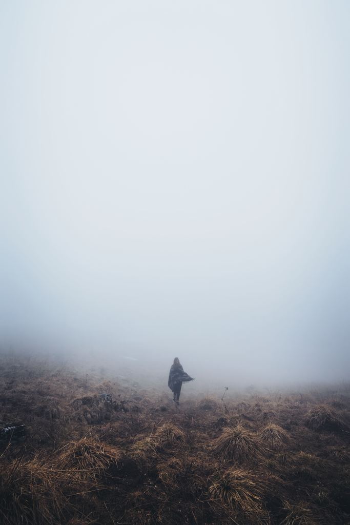 person walking in fog