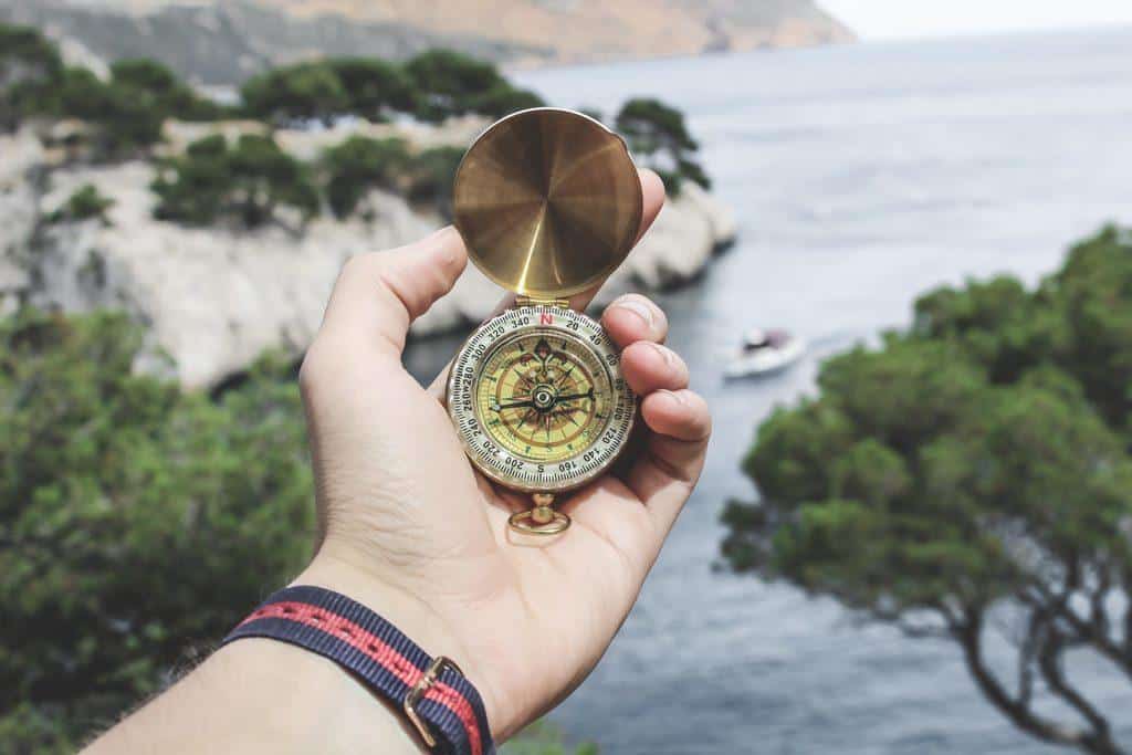 New Year's Resolution Template man holding compass in hand sea in background