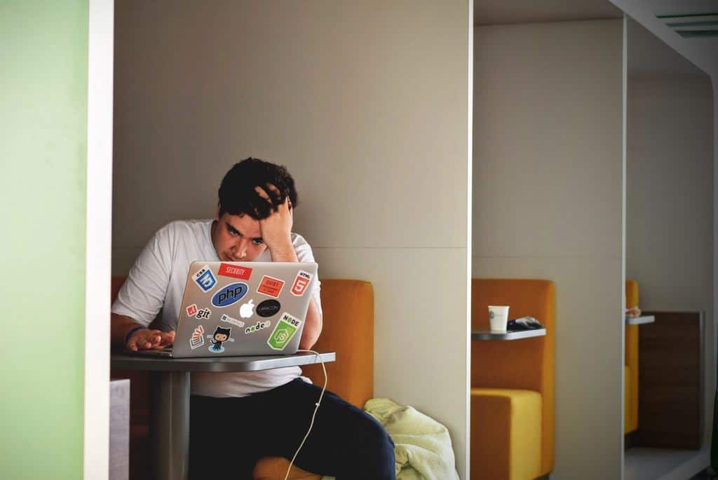 man at laptop - frustrated after hard work