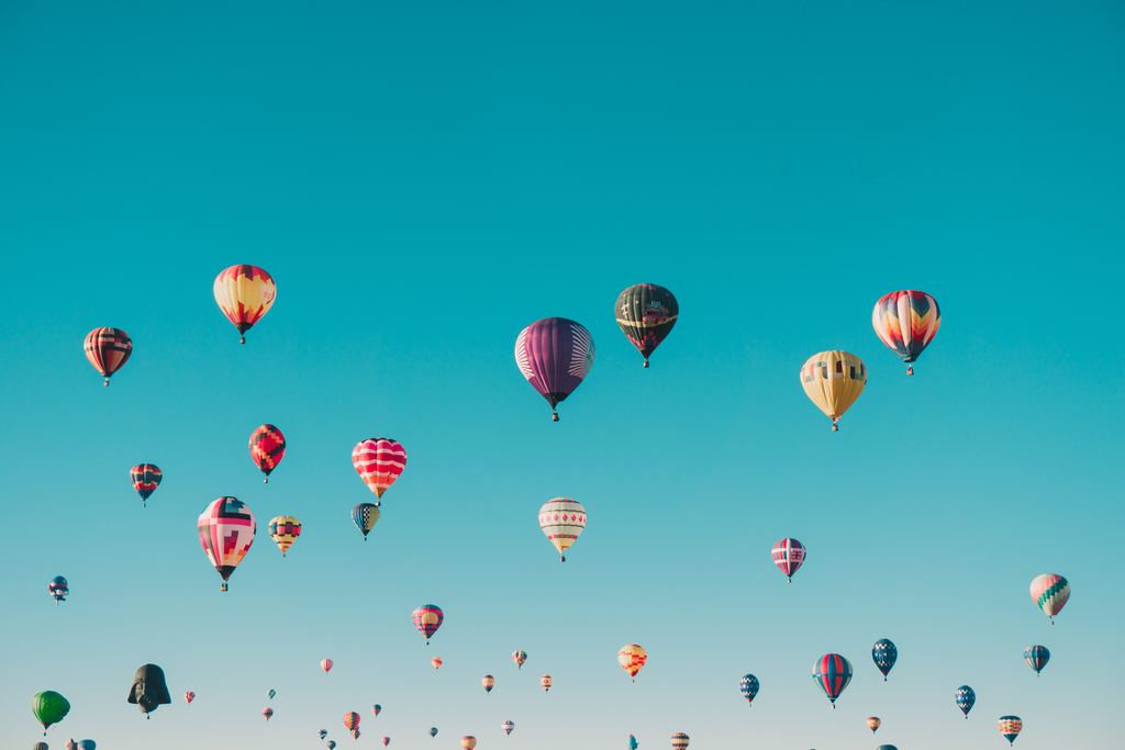 hot air balloons in a brilliant blue sky
