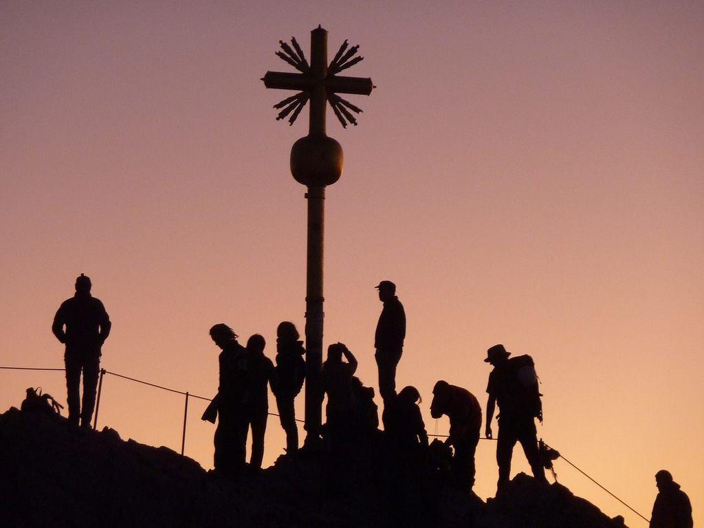 group on mountaintop with cross