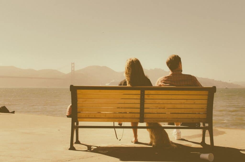 silent unhappy couple on bench not sorry